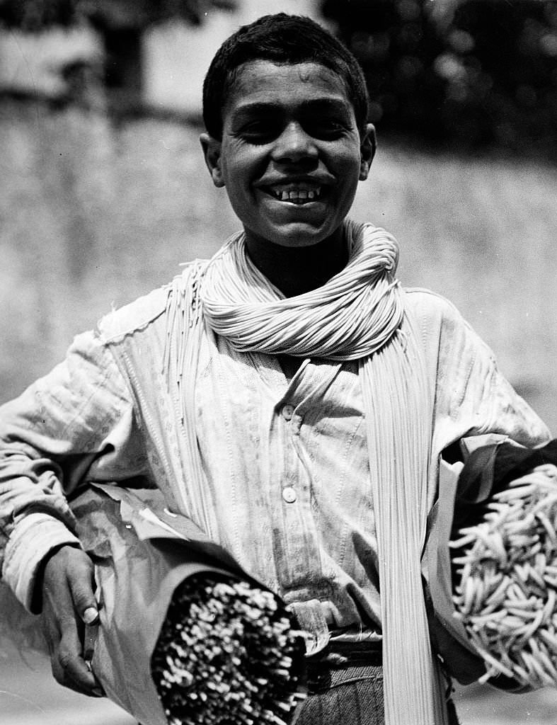 Neapolitan boy carrying two bundles of spaghetti in Italy, 1932