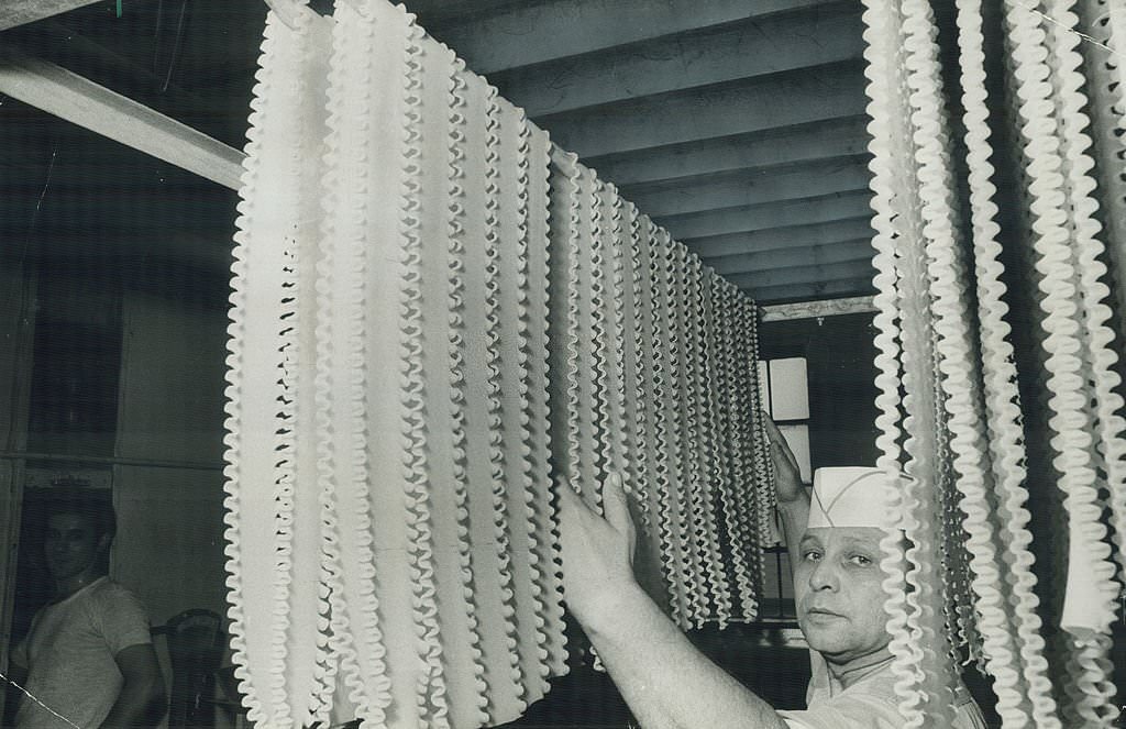 Lasagna noodles Pietro La Franco puts on a drying rack in a Toronto factory, 1970s