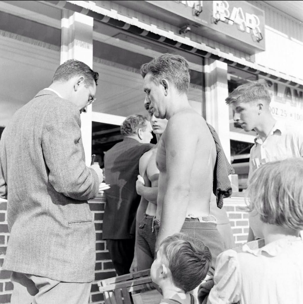 People being ticketed for 'Indecent Exposure' at Rockaway Beach of New York City, 1946