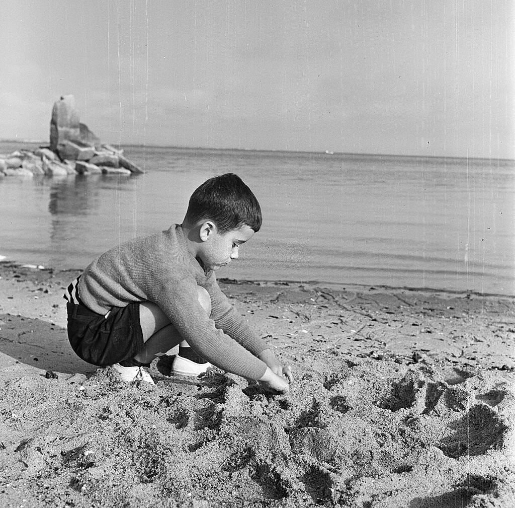 A young boy plays in the sand on the beach, Provincetown, Massachusetts, 1948.