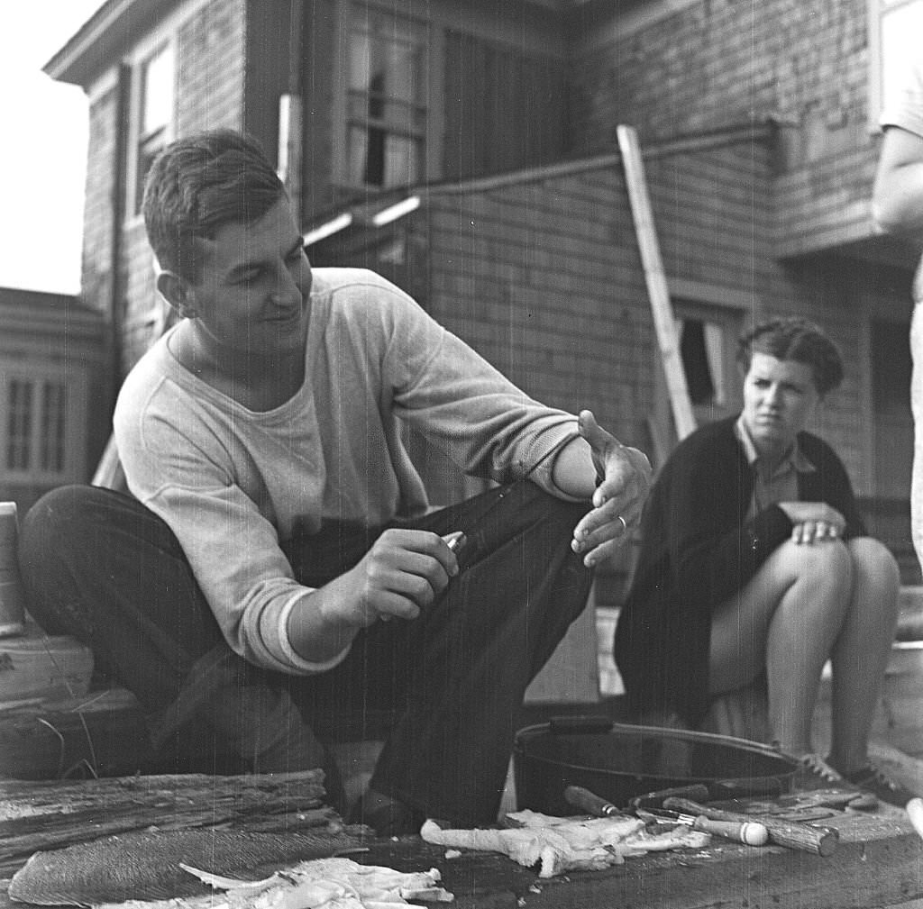 A man cleans fish for a beachside cookout, Provincetown, Massachusetts, 1948.