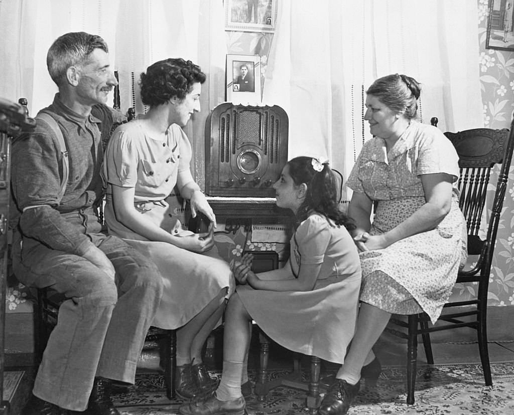 A fisherman and his family gather around a radio in their living room in Provincetown, Massachusetts.
