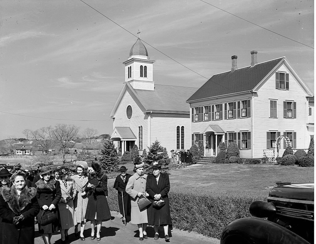 Worshipers leaving a church in the Portuguese section of Provincetown, Massachusetts during the Spring of 1942.