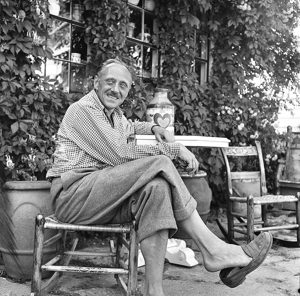 A visitor relaxes outside on the grounds of an antique shop, Provincetown, Massachusetts, 1948.