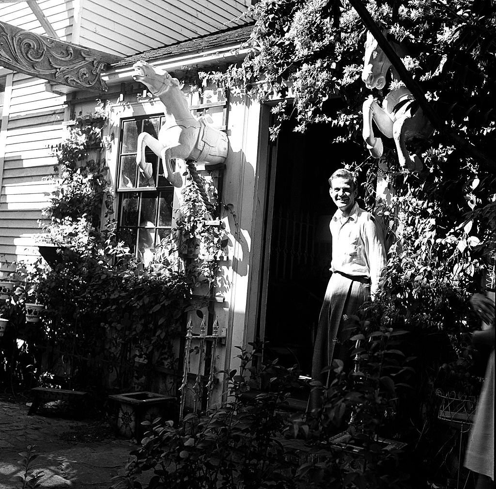 A visitor stands at the entrance to an antique shop, Provincetown, Massachusetts, 1948.