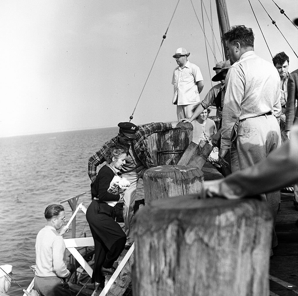 Visitors disembark from a boat at the pier, Provincetown, Massachusetts, 1948.