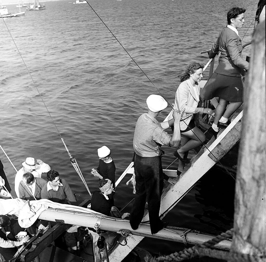 Visitors disembark from a boat at the pier, Provincetown, Massachusetts, 1948.