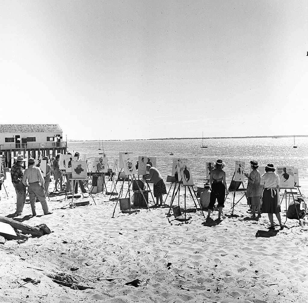 A group of painters set up their easels and paint while on the beach on Cape Cod, Provincetown, Massachussetts, 1947.