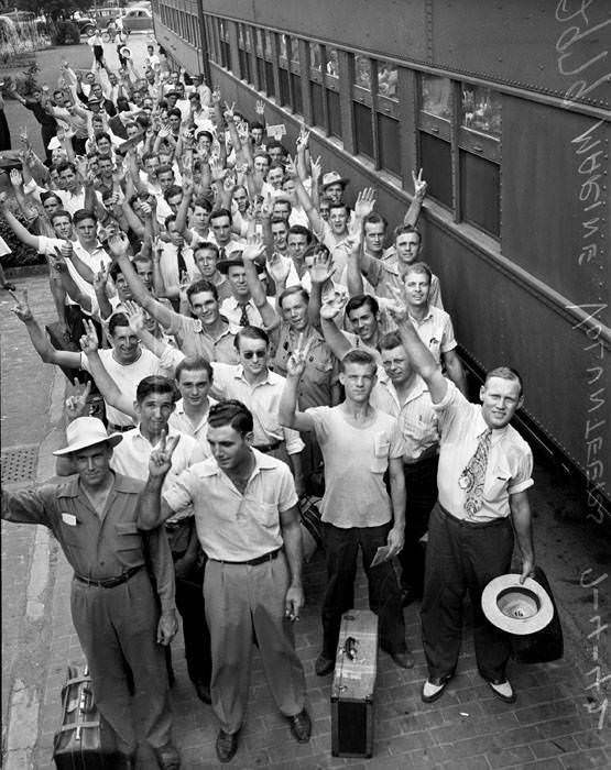 Marine volunteers posed beside train at Southern Pacific Depot, San Antonio, 1942