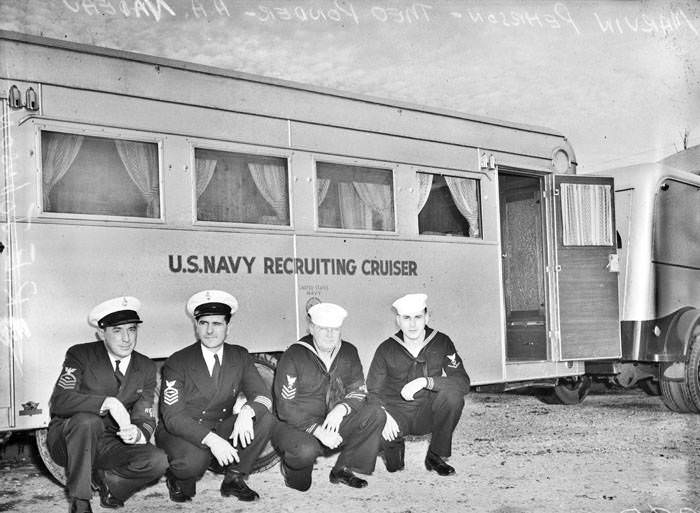 Navy recruiters beside recruiting trailor, 1942