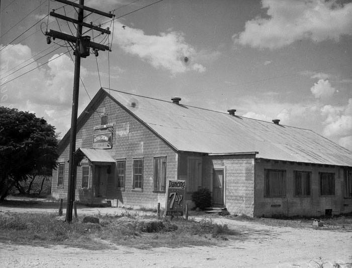 Exterior of Converse Hall, 1941. The exterior of Converse Hall with Royal Crown cola sign and 7-Up sign.