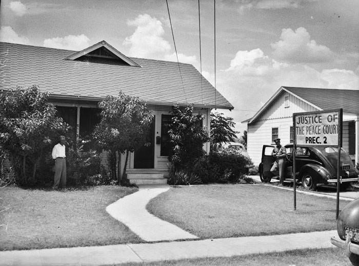 Exterior of Justice of the Peace John Geraghty's residence, 1941. South and east elevations of the building, northwest corner of W. Houston and Camaron Streets.