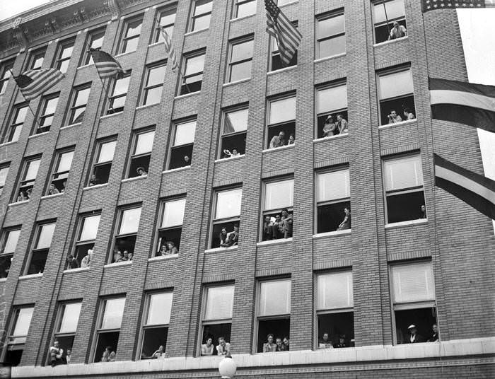 Battle of Flowers crowd in the windows of the Calcasieu Building, 1941