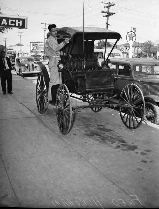 Frank Horadam putting top on reconditioned surrey, 1942