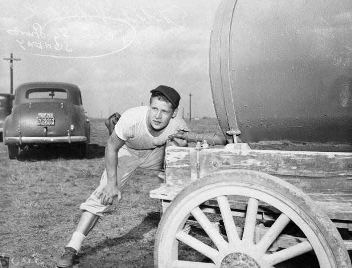 Eddie Kazak drinks from water wagon during baseball practice, 1943