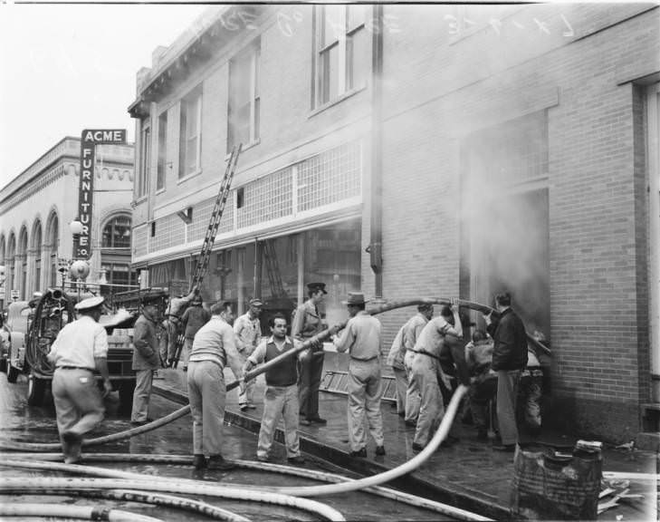 A firemen trying to extinguish a fire at the Acme Furniture Company on East Commerce, 1947