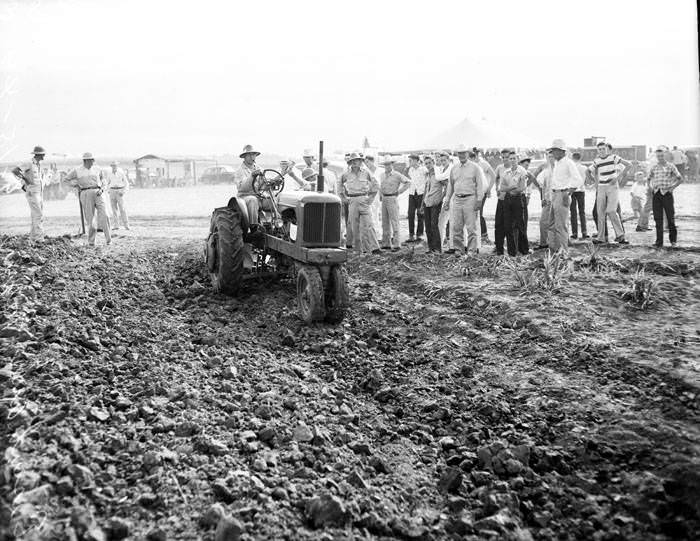 Spectators watch tractor demonstration on Eisenhauer farm near San Antonio, 1949