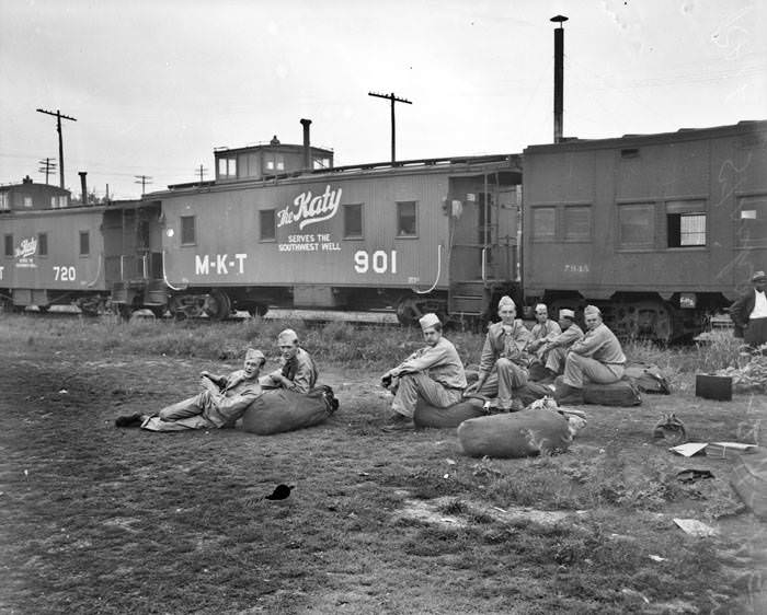 Soldiers waiting outside of train, 1946