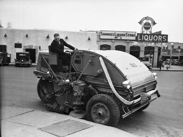 Henry Hein operating new mechanical street sweeper, 1940