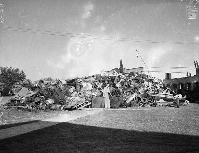 Scrap metal pile in front of Alamo Heights High School, 1942