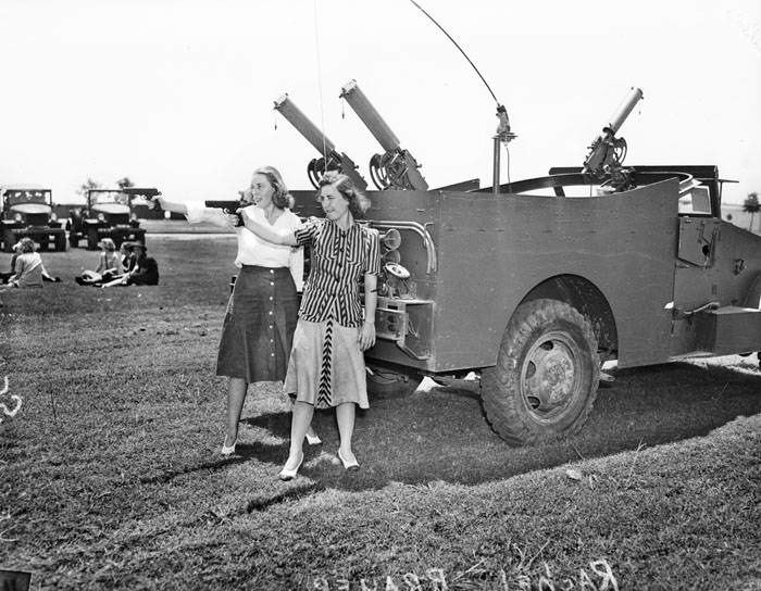 Women's Motor Corp members firing pistols, 1941