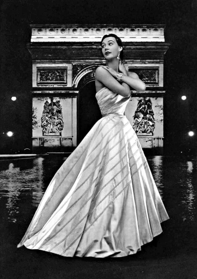 Sophie Malgat in gorgeous white satin ball gown diagonally crossed with bands of rhinestones by Christian Dior, 1951