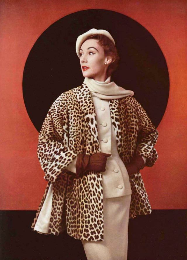 Sophie Malgat in egg-shell flannel suit with collar scarf, worn with collarless panther fur jacket that has slits on the side by Christian Dior, 1952