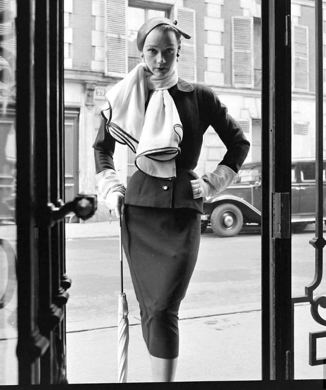 Sophie Malgat in Givenchy's slim suit worn with wide scarf, February 1952