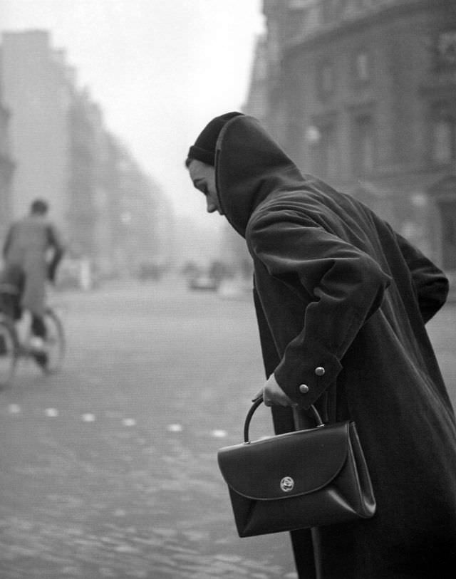 Sophie Litvak wearing coat and handbag by Jacques Fath, Elle, January 12, 1953