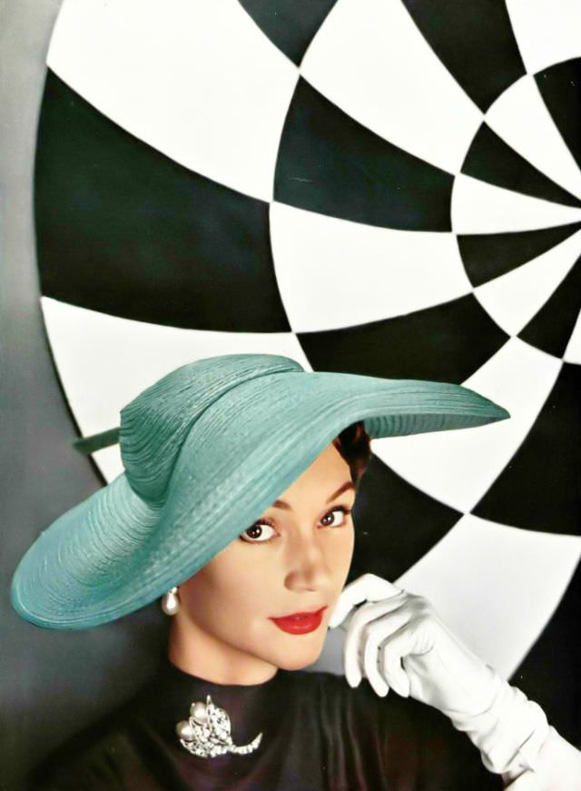 Sophie Malgat in sea-green wide-brimmed hat in wavy fabric by Legroux Soeurs, diamond and pearl brooch by Roger Scémama, 1953