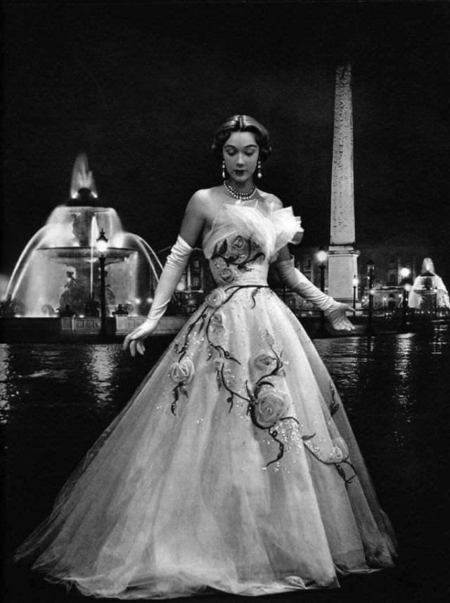 Sophie Malgat in an enchanting evening gown of white tulle adorned with pale pink roses and scattered with rhinestones by Jeanne Lafaurie, 1951