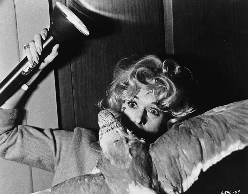 Melanie Daniels (Tippi Hedren) fights off an attacking gull in 'The Birds', 1963