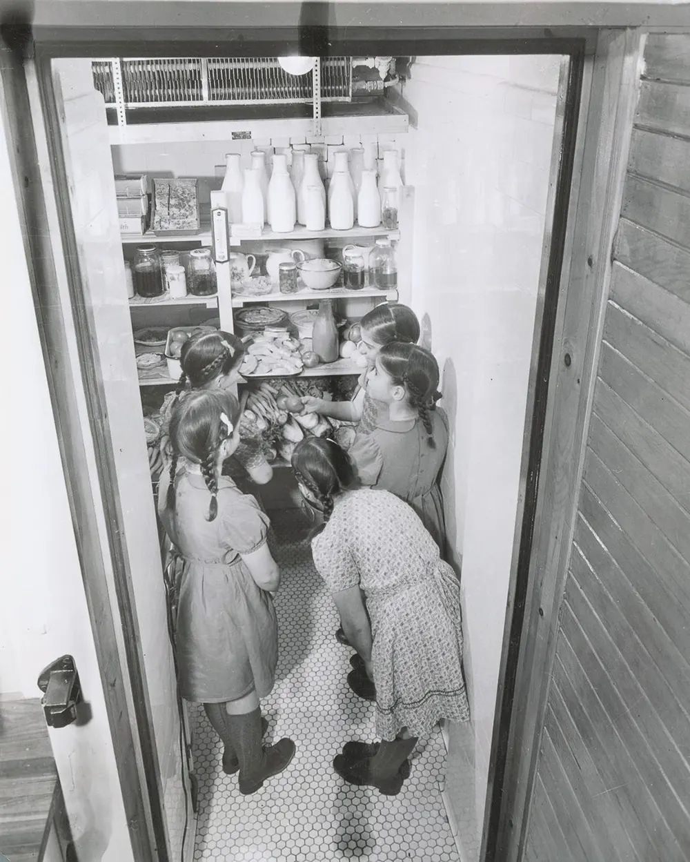 The 10-year-olds grab a snack from their refrigerator, 1944.