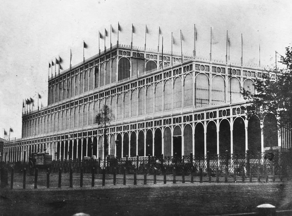 Flags flying on the eastern side of the Crystal Palace in London's Hyde Park. The massive iron and glass structure was designed by Sir Joseph Paxton as the venue for the Great Exhibition of 1851.