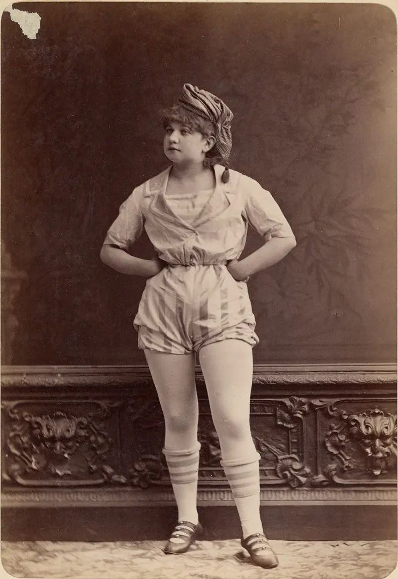 Unidentified female performer [Camille?] in a short sailor-style costume, shoes with knee-high stockings.