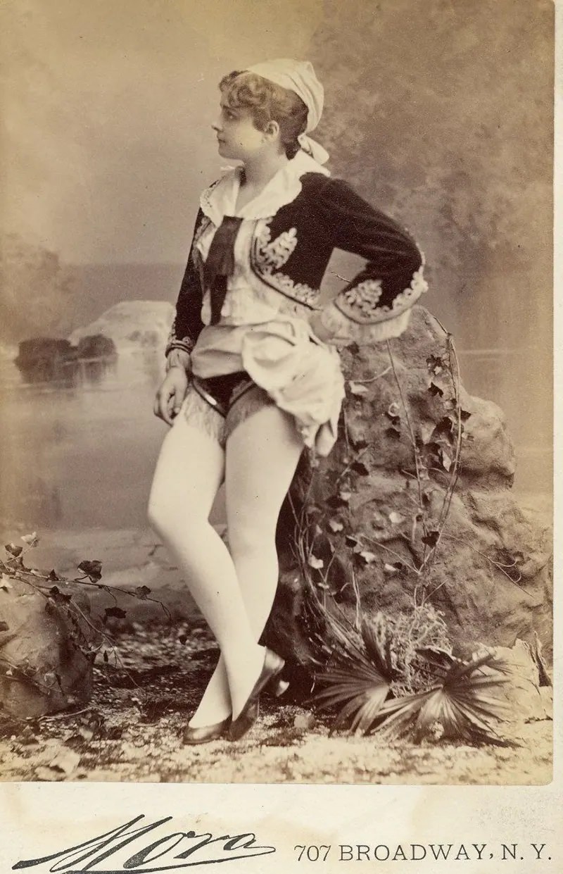 Pauline Hall in a short, Greek style costume, flat shoes.