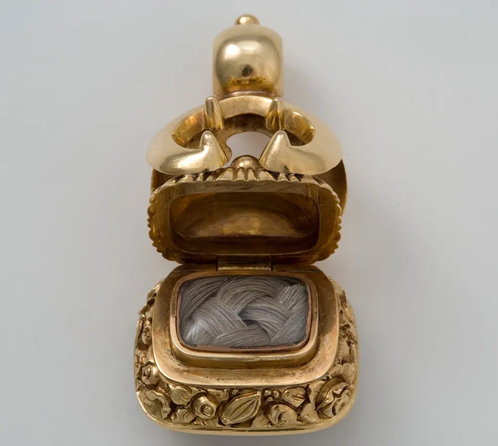 This Victorian watch fob opens to reveal plaited locks of human hair.
