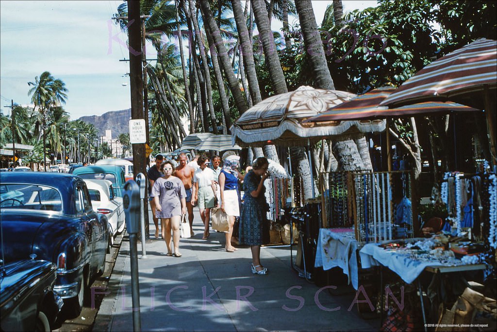 Hawaiiana and souvenir vendors on the sidewalk of Waikiki's Kalakaua Avenue fronting the Royal Hawaiian Hotel, 1961