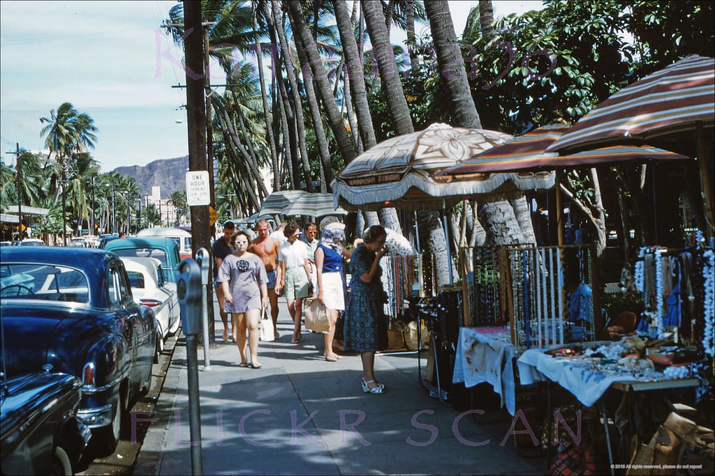 Hawaiiana and souvenir vendors on the sidewalk of Waikiki's Kalakaua Avenue fronting the Royal Hawaiian Hotel, 1961