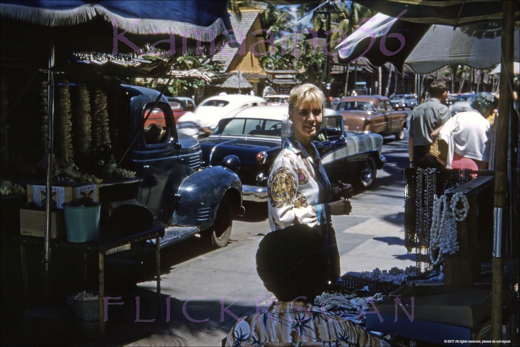 Our pretty blonde snapped amid the lei sellers and tourists on the makai sidewalk of Waikiki’s Kalakaua Avenue, 1960