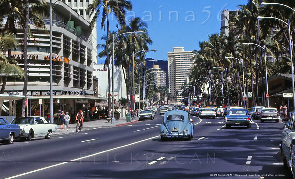 Two-way traffic and on-street parking along Waikiki’s busy Kalakaua Avenue at Royal Hawaiian Avenue, 1966