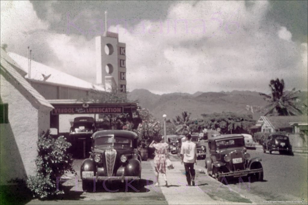Looking mauka along Kalaimoku Street in Waikiki. You could get your car lubed while taking in a movie, 1946