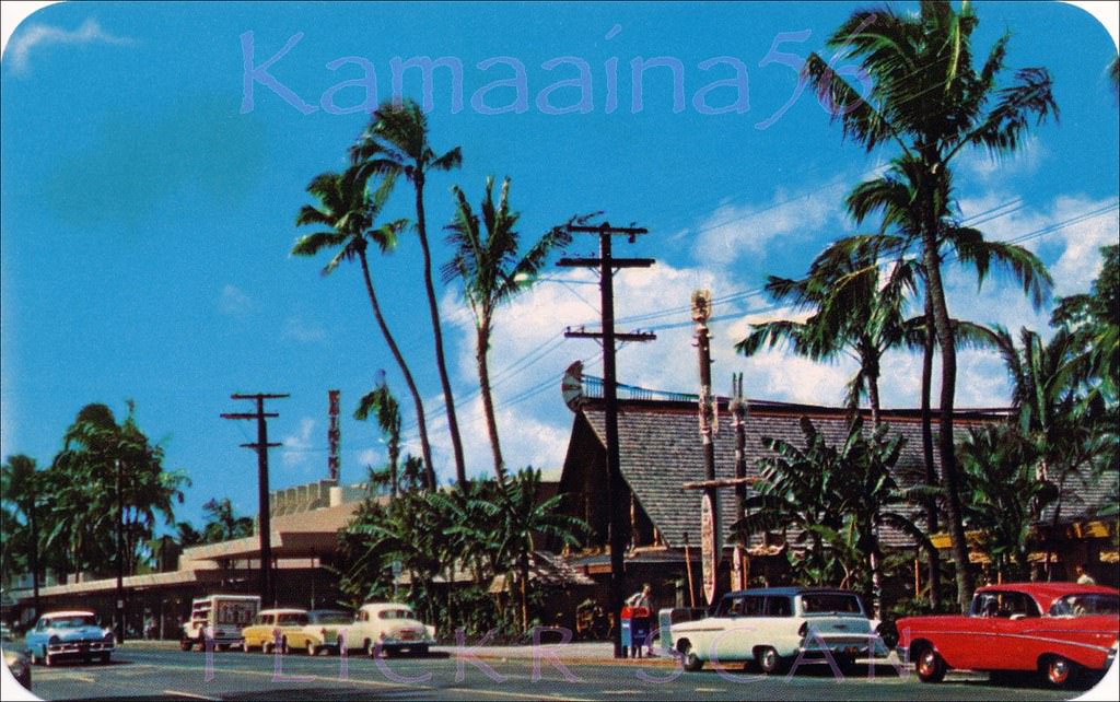 International Market Place in the foreground with Liberty House Waikiki department store to the left and the Waikiki Theatre visible above the roof of Liberty House, 1958