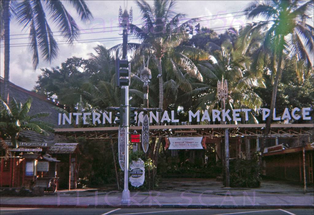 Morning light in Waikiki looking across Kalakaua Avenue at the International Market Place, 1962