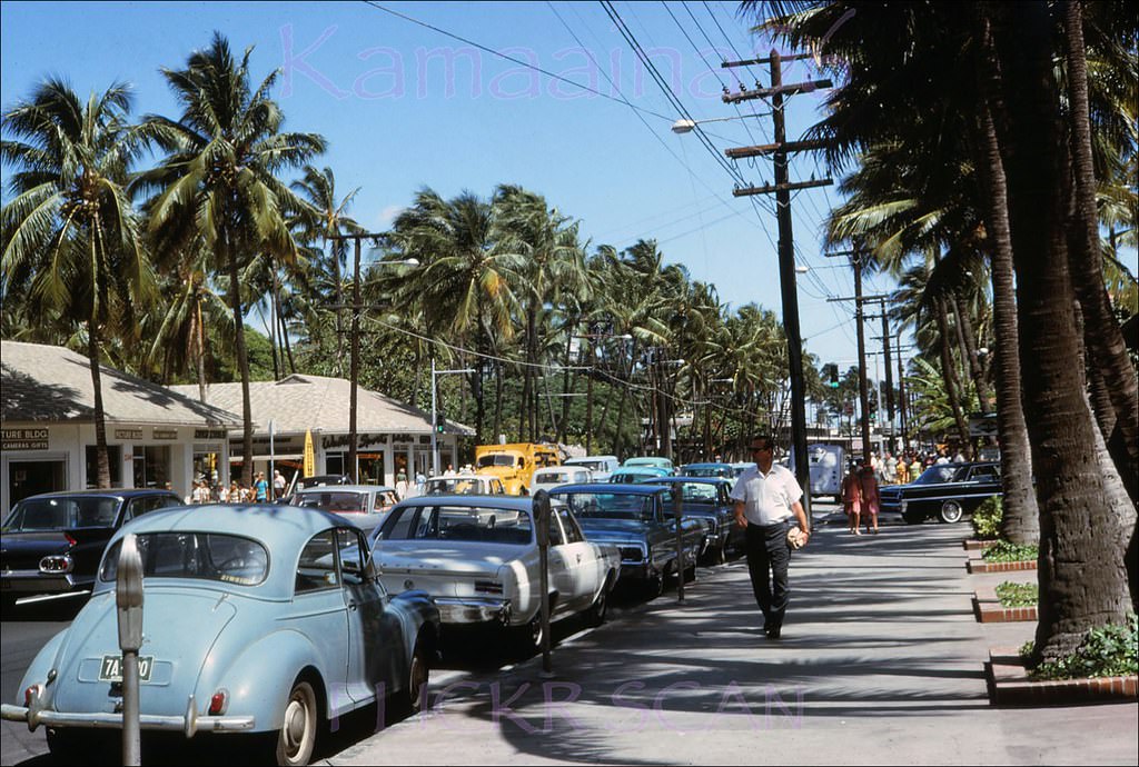 Looking ewa along Kalakaua Avenue in Waikiki from around the Princess Kaiulani Hotel storefronts, 1964