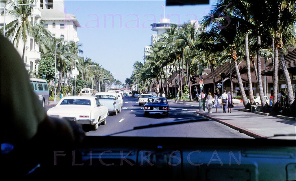 Bus driver's eye view looking west along Waikiki’s Kalakaua Avenue at the intersection with Kaiulani when Kalakaua was still a two-way street, 1966