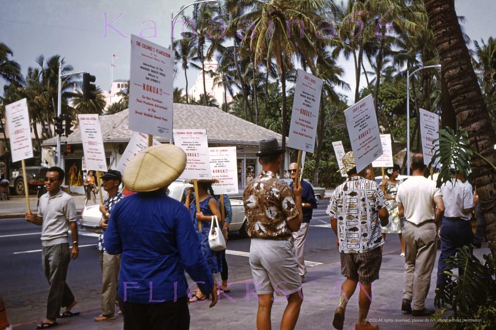 Waikiki Beach Press picketers protesting on Kalakaua Avenue in front of the International Market Place, 1965