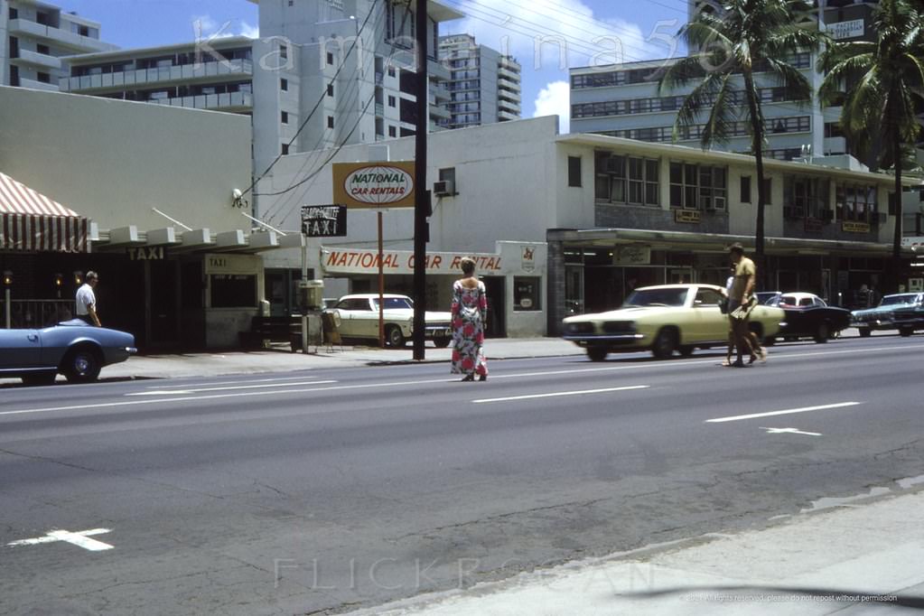 View is looking mauka (inland) side of Waikiki’s Kalakaua Avenue just Ewa (west) of Lewers Street, 1968.