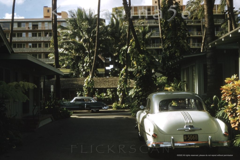 The vantage point here was the driveway at the low-rise Coconut Grove Hotel on Waikiki’s Lewers Road with the Edgewater Hotel towers in the background, 1953.