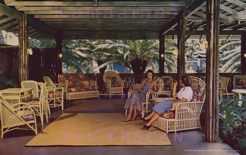 Ladies enjoying a smoke in the rattan furnished Lanai Lounge at the Willard Inn, Waikiki, 1940s
